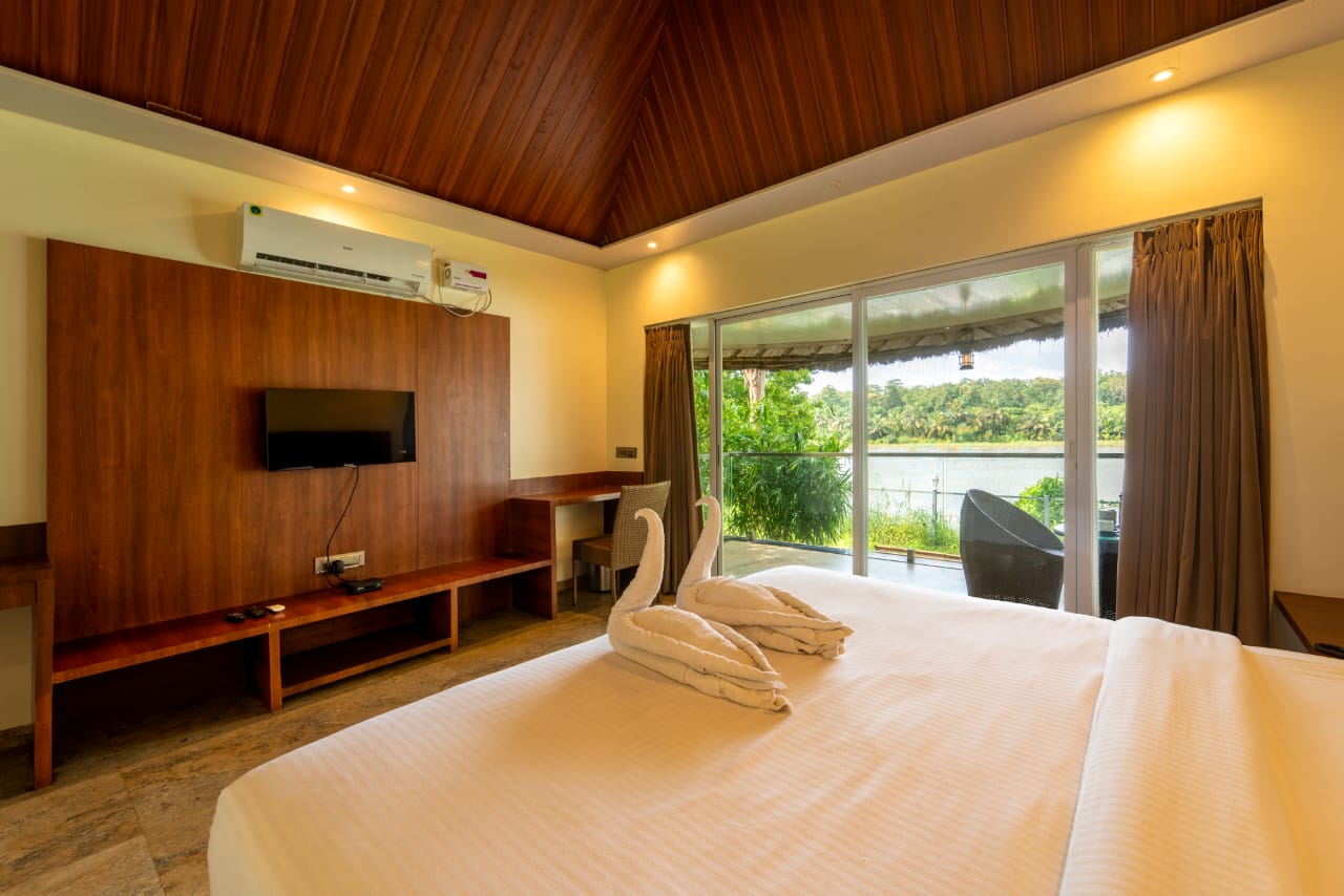 Elegant interior of river cottage with teak furniture